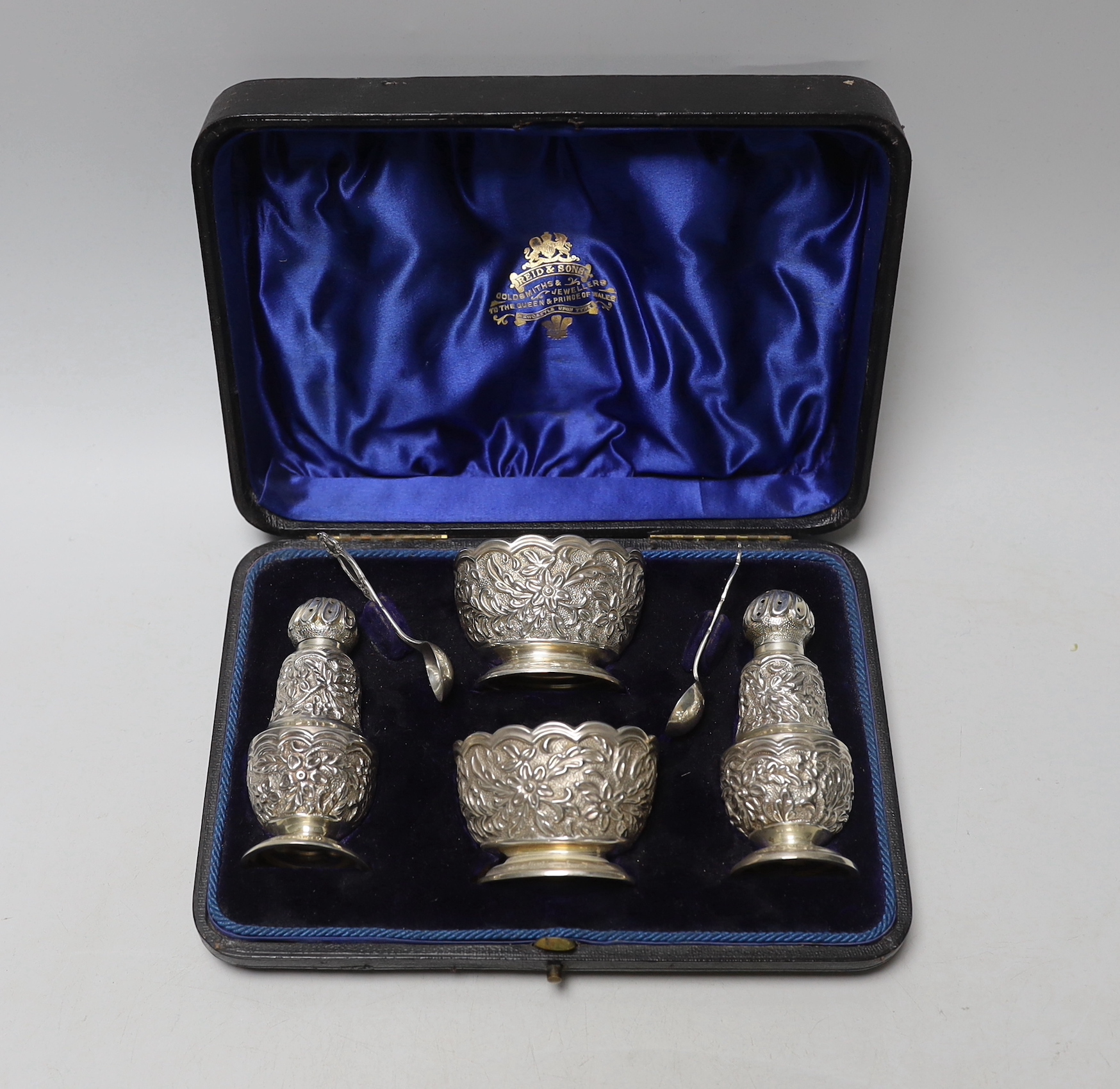 A cased late Victorian Anglo Indian style four piece silver condiment set with two matching spoons, Horton & Allday, Birmingham, 1892, one pepper not hallmarked?